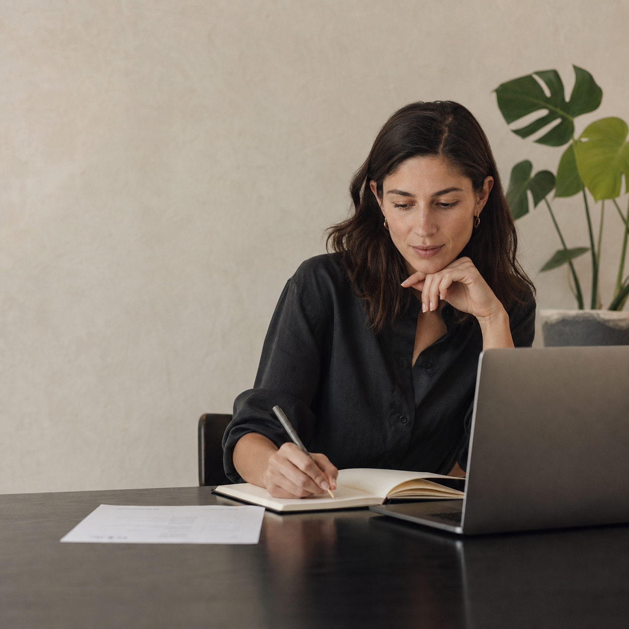 A professional thoughtfully planning her next career move at a calm home workspace